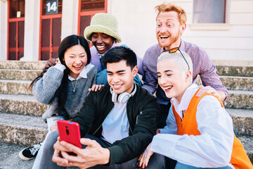 Obraz premium group taking a selfie photo with a smartphone sitting on the floor.