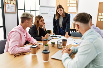 Group of business workers listening hispanic boss woman conference at the office.