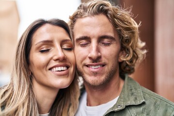 Man and woman couple smiling confident standing together at street