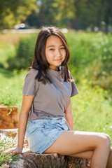 Portrait of a young beautiful girl in summer park