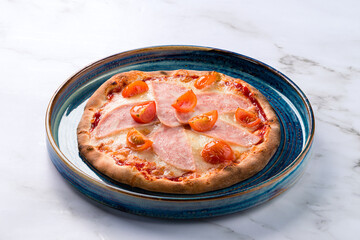 Pizzete. Home baked mini pizzas with ham, cheese. Italian cuisine