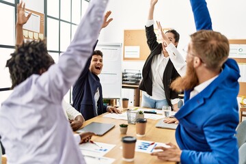 Fototapeta premium Group of business workers smiling happy celebrating with hands together at the office.