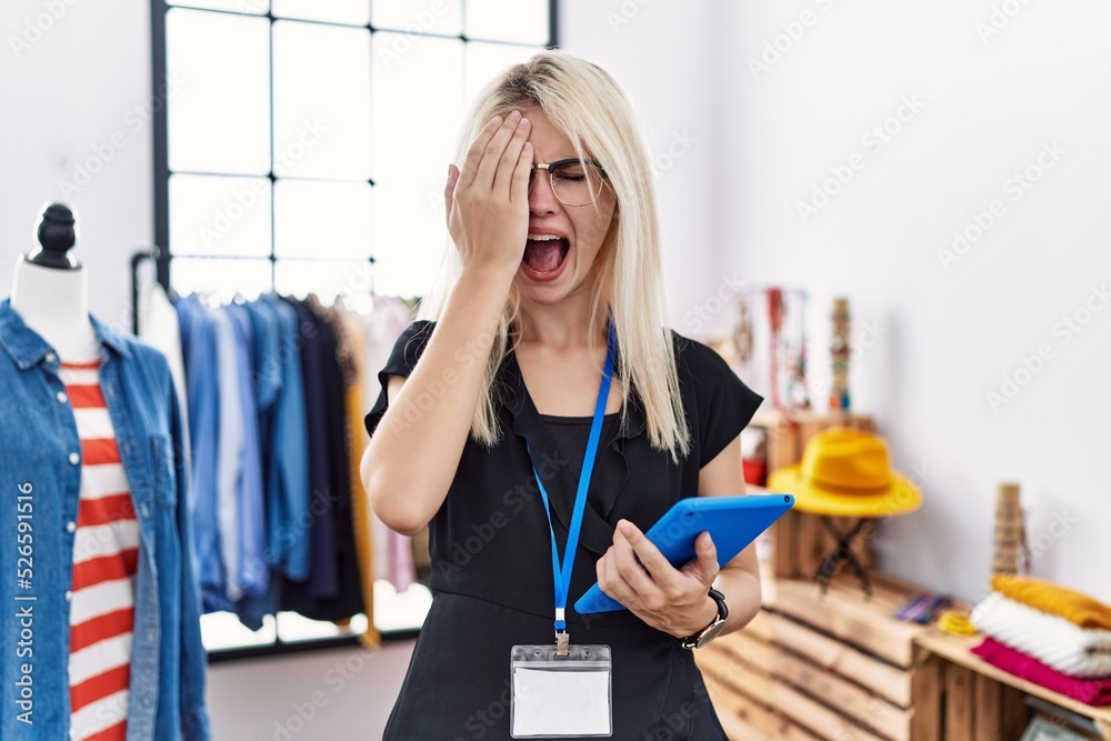 Sticker Young blonde woman working as manager at retail boutique yawning tired covering half face, eye and mouth with hand. face hurts in pain.