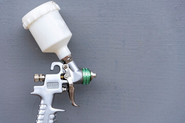 Paint spray gun for painting on a gray background