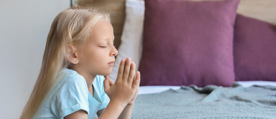 Little girl praying at home