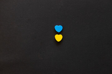 Two hearts of color Ukraine flag on black background