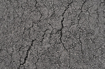 Surface of new clean cracked asphalt. Top view.