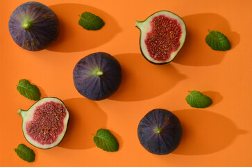 fruits figs and mint leaves, colorful background with hard shadows