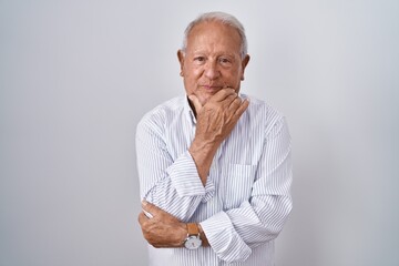 Senior man with grey hair standing over isolated background looking confident at the camera smiling...