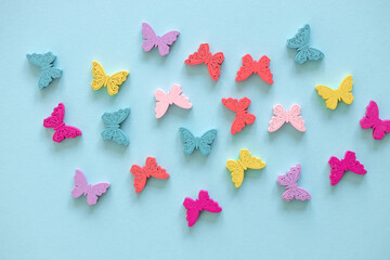 Colored figures in the form of butterfly on a blue background