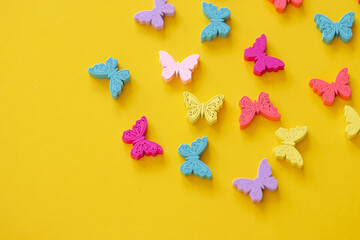 Colored figures in the form of butterfly on a yellow background