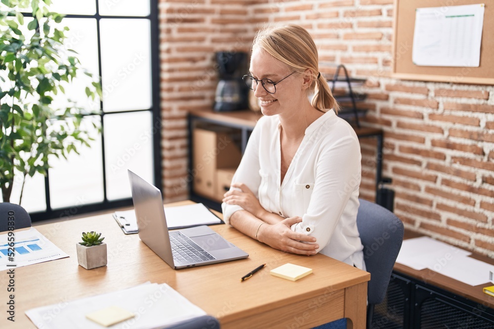 Sticker young blonde woman business worker using laptop writing on reminder paper at office