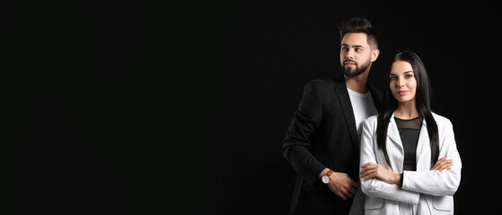 Stylish young couple with dark hair on black background with space for text