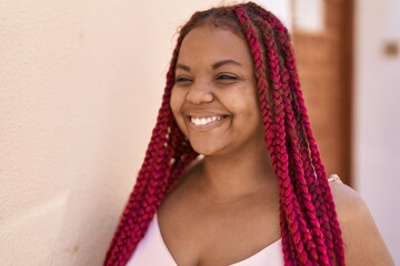 African american woman smiling confident looking to the side at street