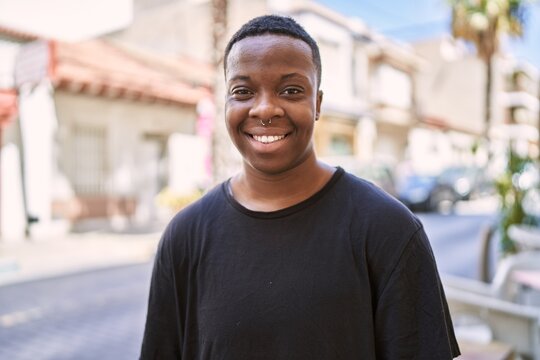 Young african american transgender smiling confident at street