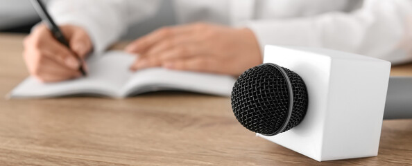 Microphone on table of journalist in office, closeup