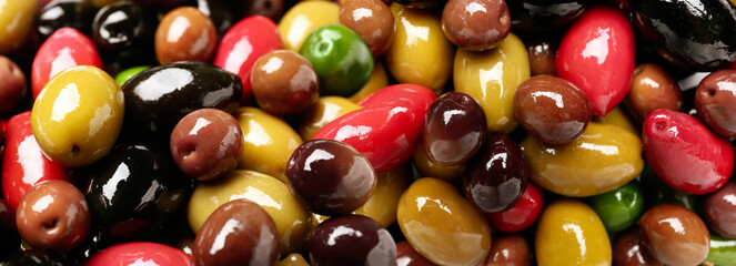 Different types of tasty olives as background, closeup