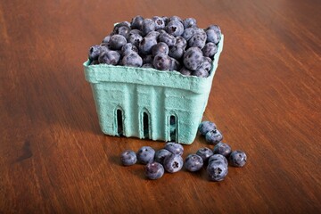 Pint of blueberries on a rustic wooden table