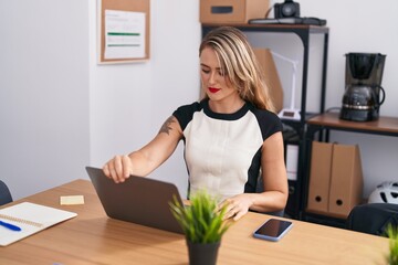 Young beautiful hispanic woman business worker using laptop working at office