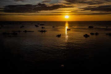 Beautiful top view of the sea at sunset with fisher boats in Vietnam