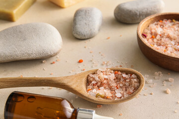Spoon of sea salt on light background, closeup