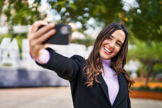 Young hispanic woman smiling confident make selfie by the smartphone at park