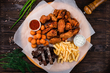 snacks for beer with different sauces on parchment