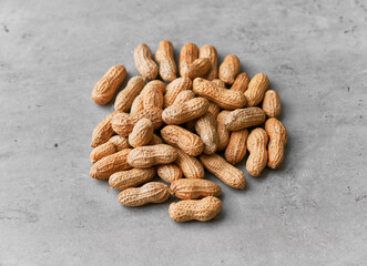 Image of bunch of peanuts on a concrete surface