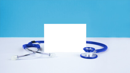 Template and stethoscope on a blue background. Place for text.