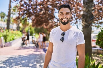 Young arab man smiling happy standing at the city.