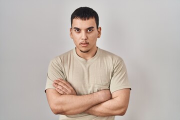 Young arab man wearing casual t shirt skeptic and nervous, disapproving expression on face with crossed arms. negative person.