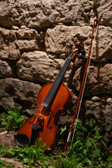 violin and bow near the wall with nice light