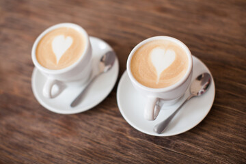 close up of a mug of cappuccino with a paint heart