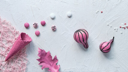 Pink Fall decor. Panoramic banner image. Stripy pumpkins, dry Autumn leaves, flower and ice cream...
