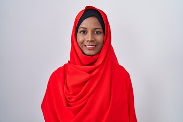 Young arab woman wearing traditional islamic hijab scarf with a happy and cool smile on face. lucky person.