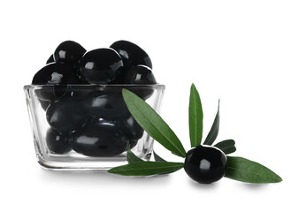 Glass bowl of tasty black olives on white background