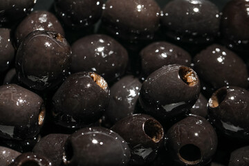Texture of black olives as background, closeup