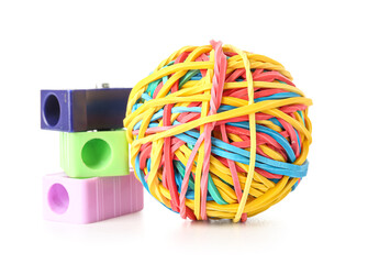Colorful rubber band ball and sharpeners on white background