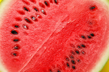 Half of tasty watermelon with seeds on yellow background, closeup