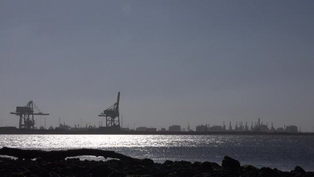 Teesside industry near Newcastle view from Redcar across water in morning light. Industrial landscape in the North of England by water UK 4K
