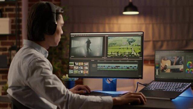 Creative artist editing film montage with visual effects on video editor software, listening to music on headphones. Working with color grading on multimedia app to create movie production.