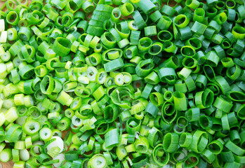 Chopped green onions or leeks shot from above.