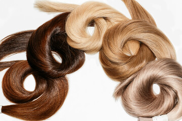 Curved hair samples for extension rolled up,different colors.White background.