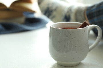 Fototapeta na wymiar Cup of delicious mulled wine indoors. Winter drink