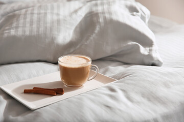 Fototapeta na wymiar Tray with morning coffee on soft blanket. Space for text