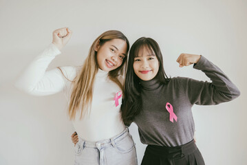 Young Asian women with pink ribbons, breast cancer awareness, October pink concept, world cancer day