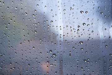 dew drops over glass window a raining day.