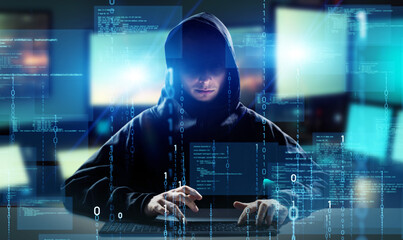 Hacker in PC room. Cyber crime. Wide image for banners, advertisements.