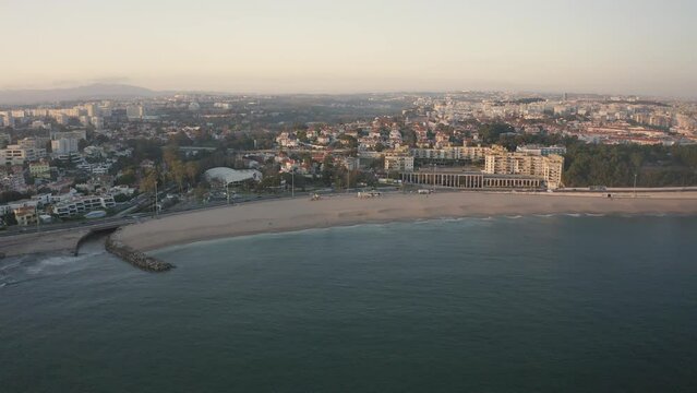 Aerial view over Santo amaro beach in Oeiras, sunset in Portugal - drone shot
