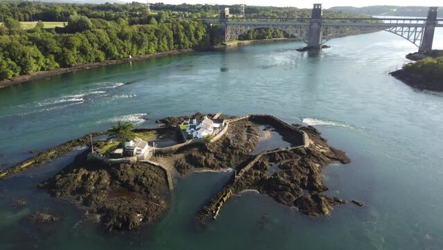 Aerial view of Menai Straits private island property with Pont Britannia bridge surrounded by Swellies clear turquoise river